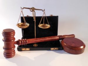 Scales of justice next to a gavel and block